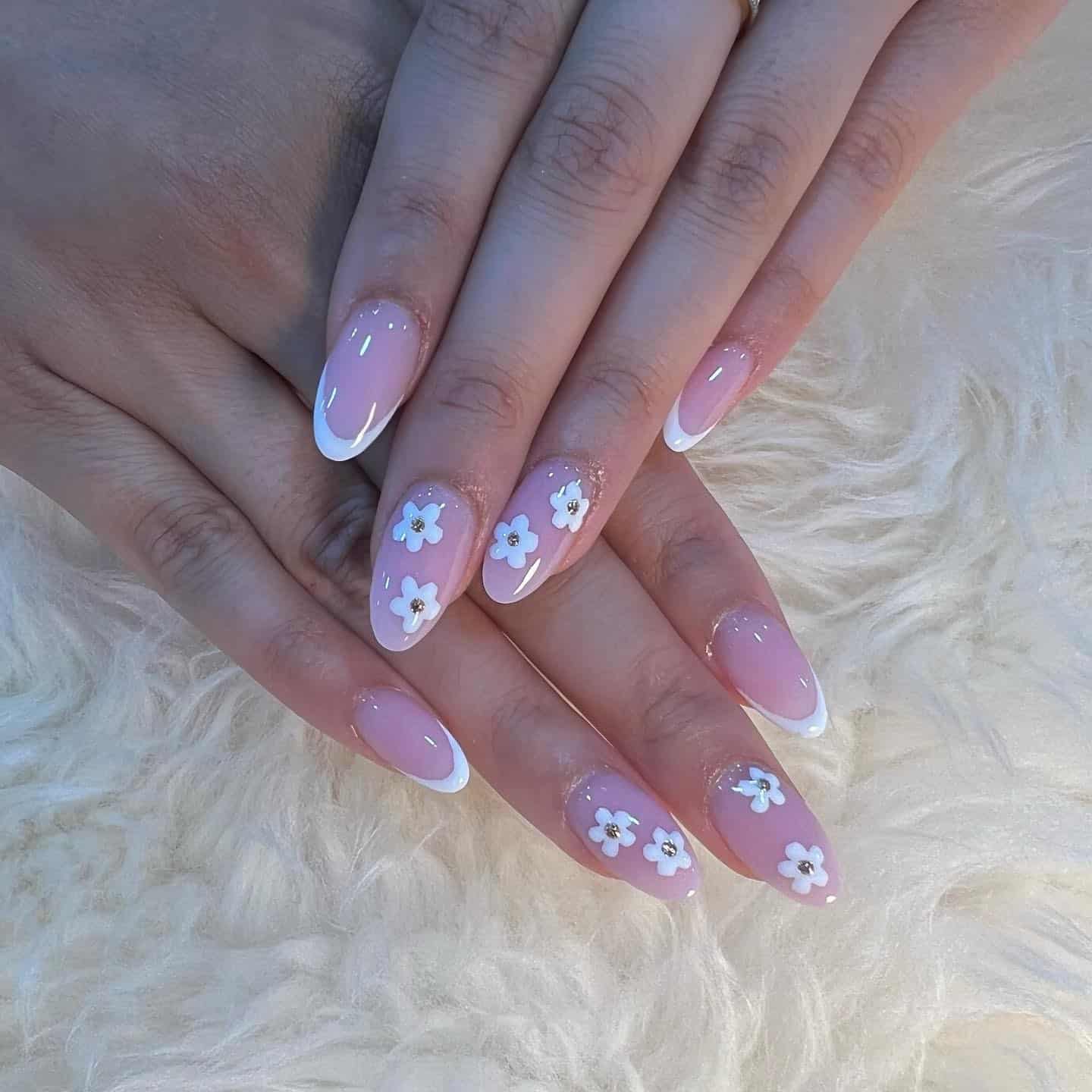 7. Soft Pink French Tips with White Floral Accents - nautical nail ideas