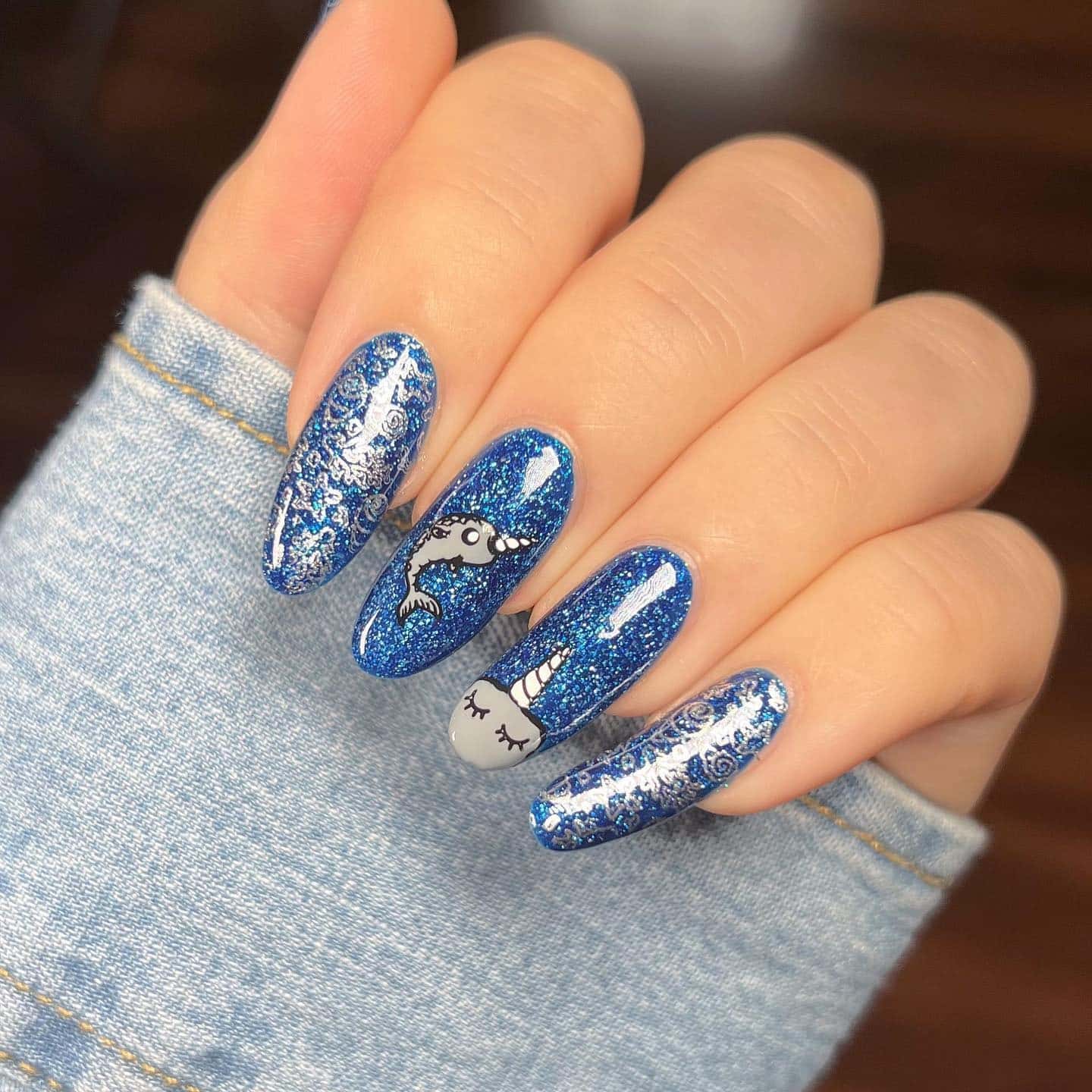 17. Blue Glitter Almond Nails with Nautical Character Art - nautical nail ideas