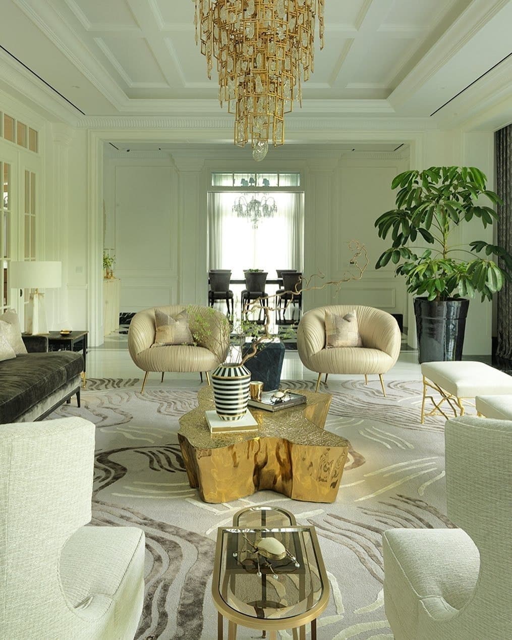 21. Elegant Neutral Living Room with Sculptural Gold Centerpiece - gold living room ideas