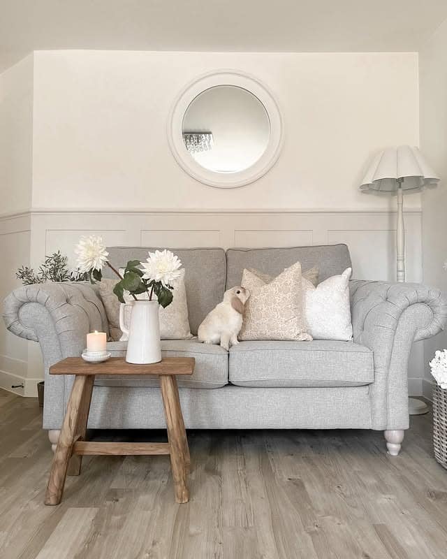 4. Classic Round Mirror with Traditional Grey Sofa - living room mirror ideas