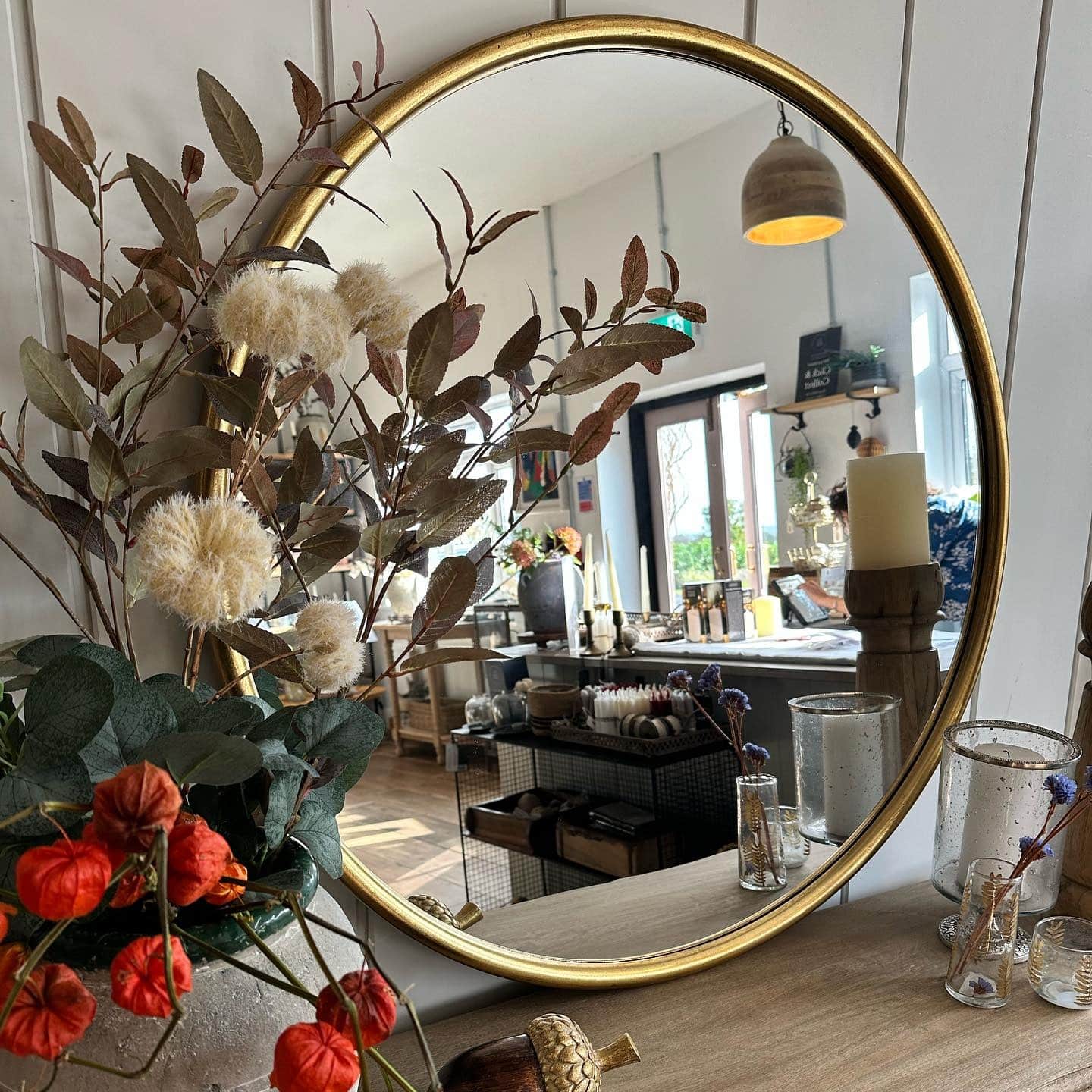 10. Round Gold-Framed Mirror with Earthy Living Room Decor - living room mirror ideas