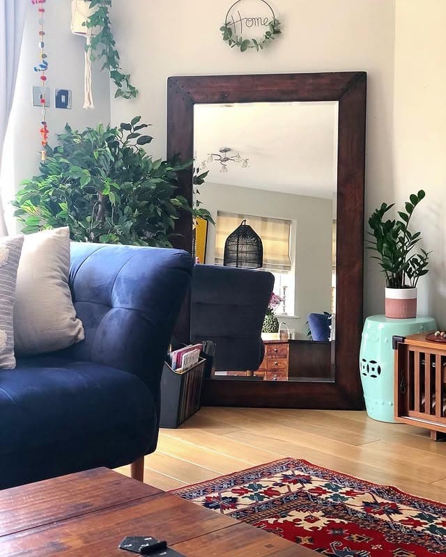 13. Oversized Floor Mirror with Earthy Living Room Styling - living room mirror ideas