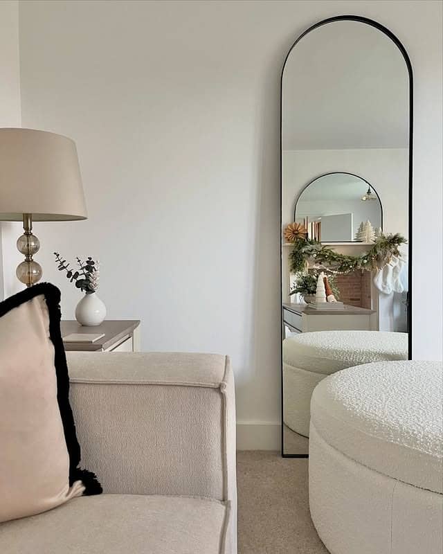 20. Slim Arched Mirror with Soft Cream Living Room Decor - living room mirror ideas