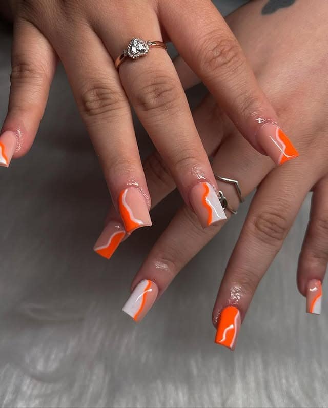 3. Soft Nude Coffin Nails with Orange Line Art - orange and white nail ideas