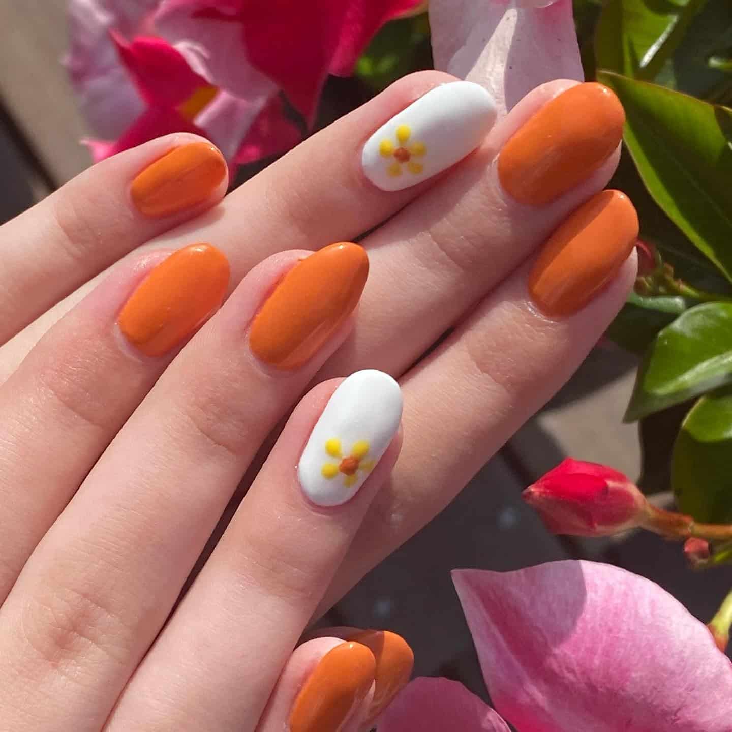 7. Orange and White Daisy Accent Nails - orange and white nail ideas