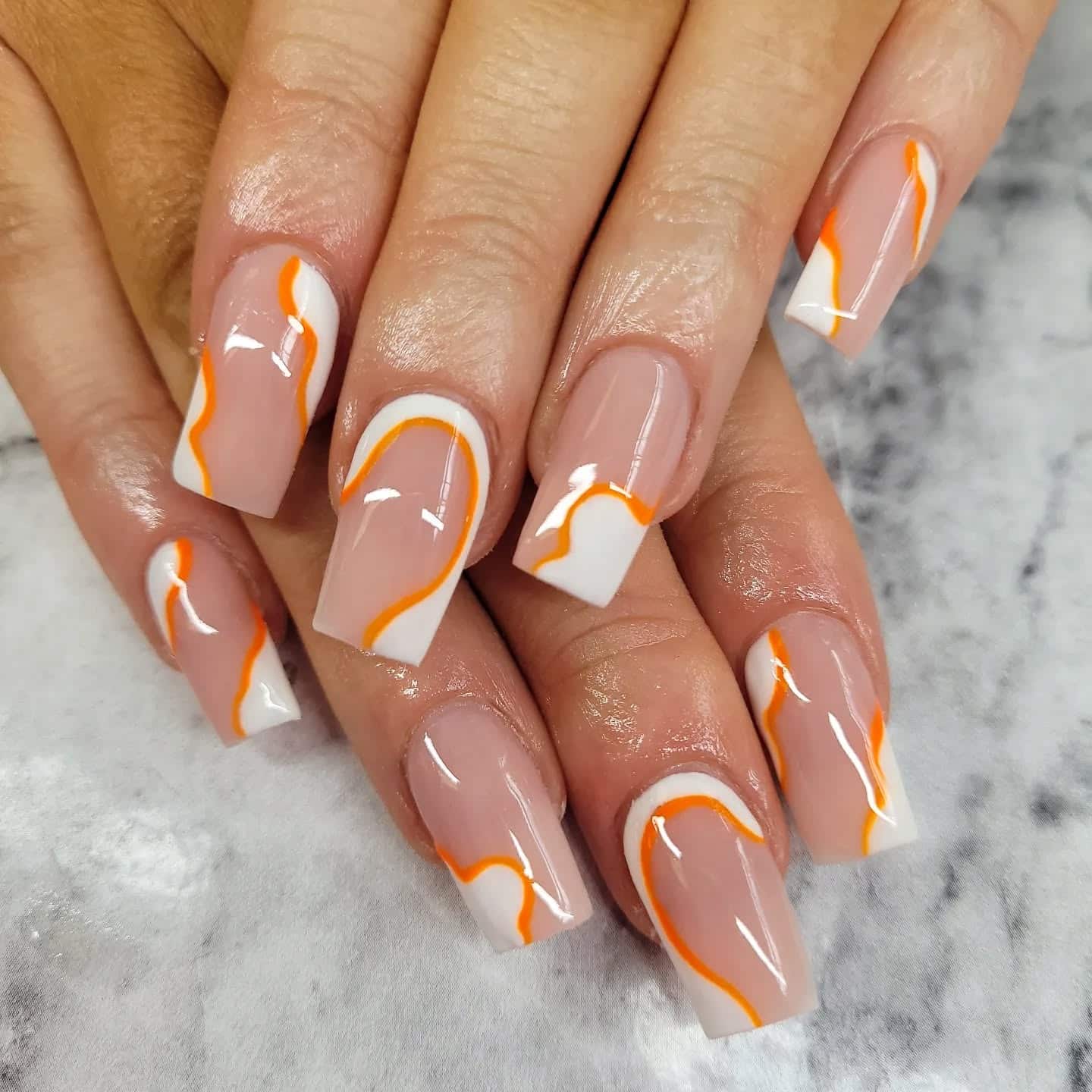 8. Classic Nude Coffin Nails with Orange Contour Lines - orange and white nail ideas