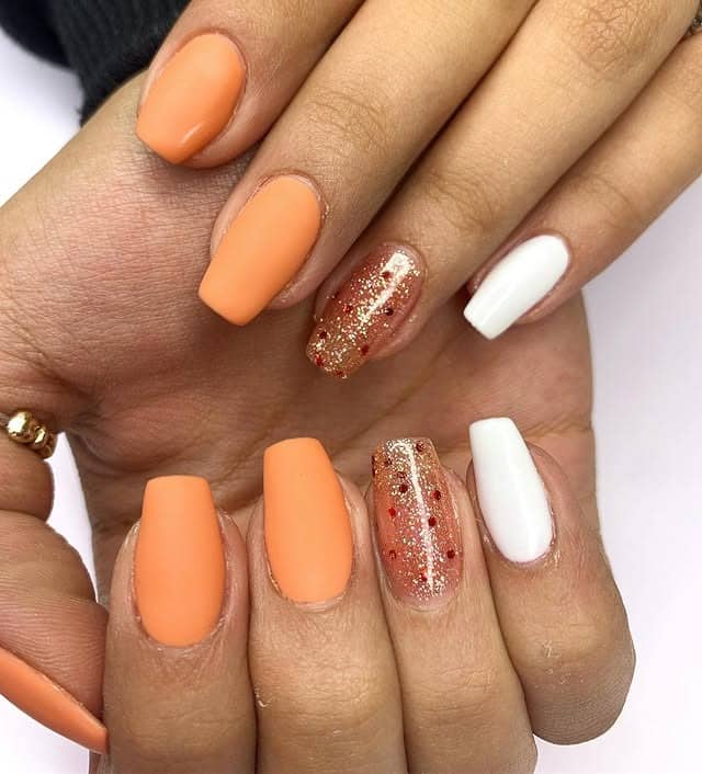 15. Matte Orange Nails with White and Gold Glitter Accent - orange and white nail ideas