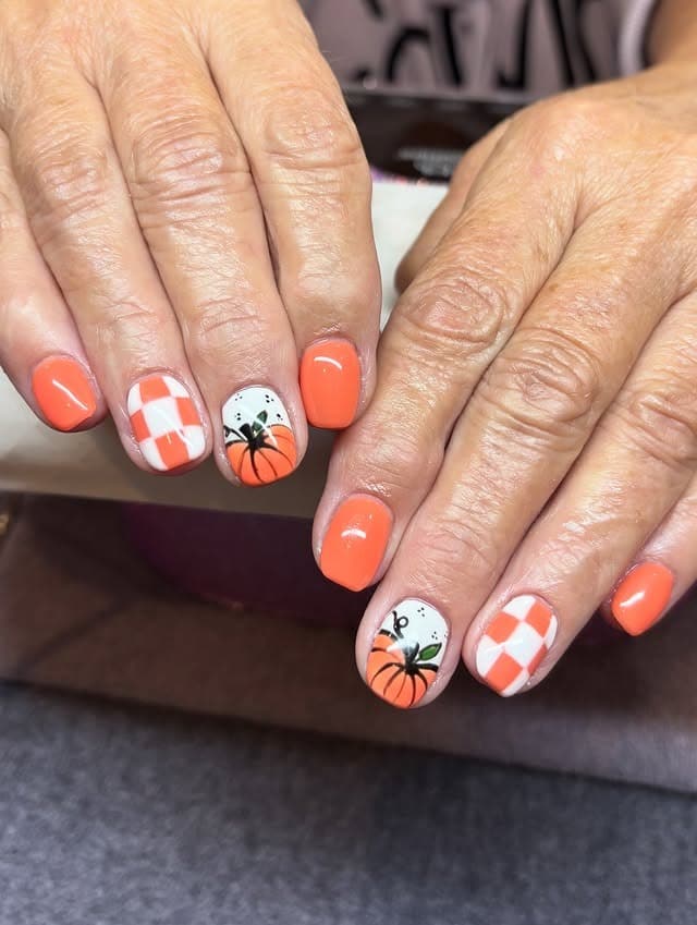 18. Short Orange Nails with White Checker and Pumpkin Art - orange and white nail ideas