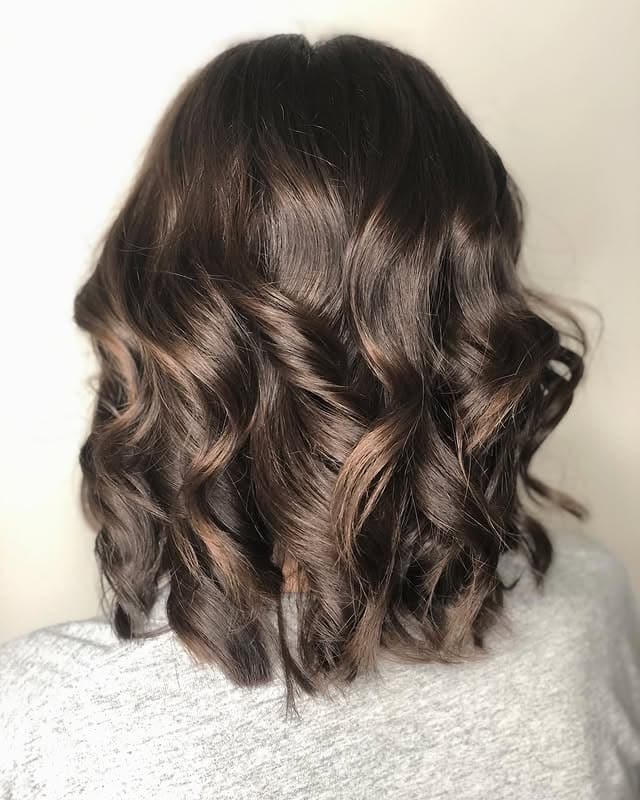 6. Glossy Dark Brown Curls with Subtle Dimension - Dark Brown Hair with Highlights