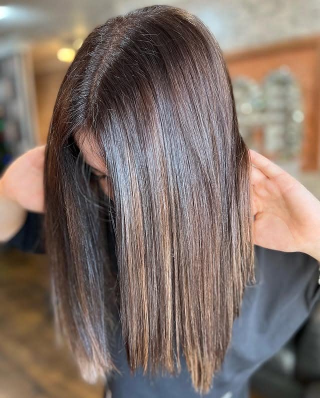 12. Sleek Dark Brown Cut with Fine Golden Highlights - Dark Brown Hair with Highlights