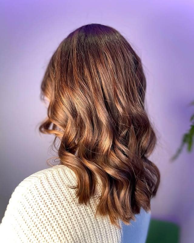 18. Medium-Length Dark Brown Waves with Golden Ribbons - Dark Brown Hair with Highlights