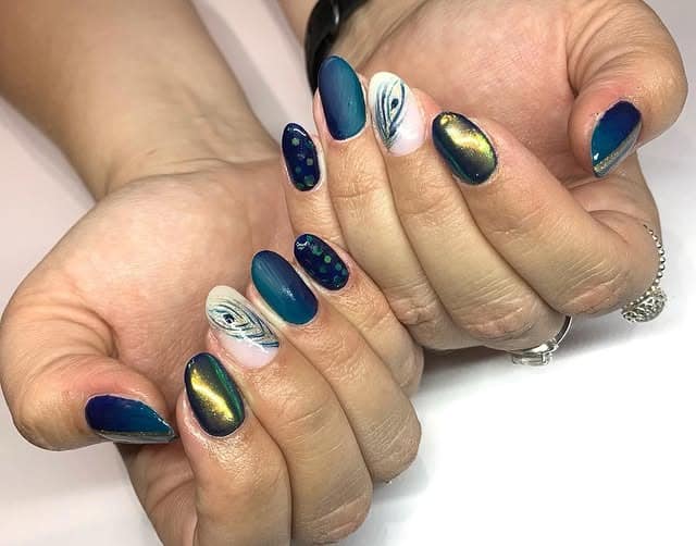 6. Deep Blue Peacock Accent Nails - peacock nail ideas
