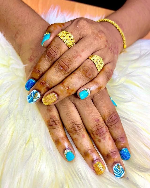 17. Turquoise and Gold Peacock Statement Nails - peacock nail ideas