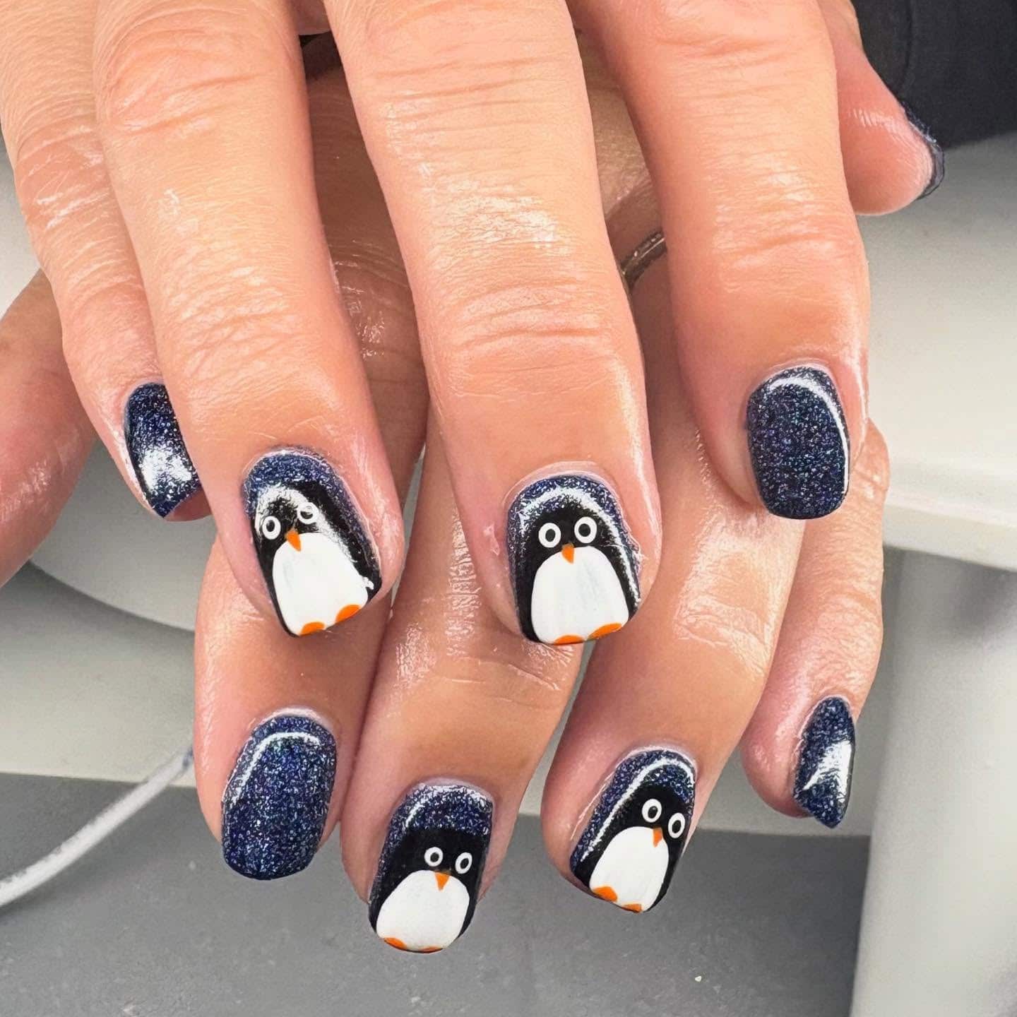 9. Textured Blue Penguin Sweater Nails - penguin nail ideas