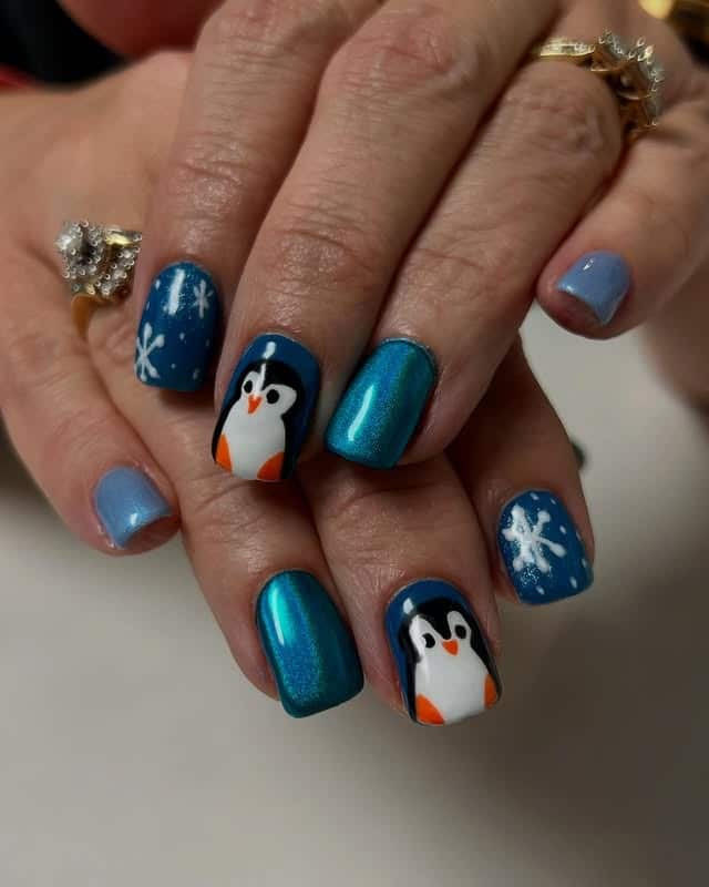 16. Teal Shimmer Penguin Snowflake Nails - penguin nail ideas