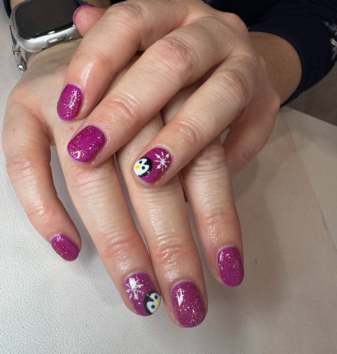 21. Plum Glitter Penguin Accent Nails - penguin nail ideas