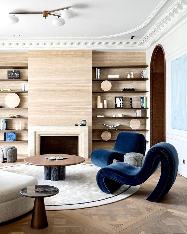 2. Sculptural Navy Seating with Warm Gray Architecture - navy blue and gray living room ideas