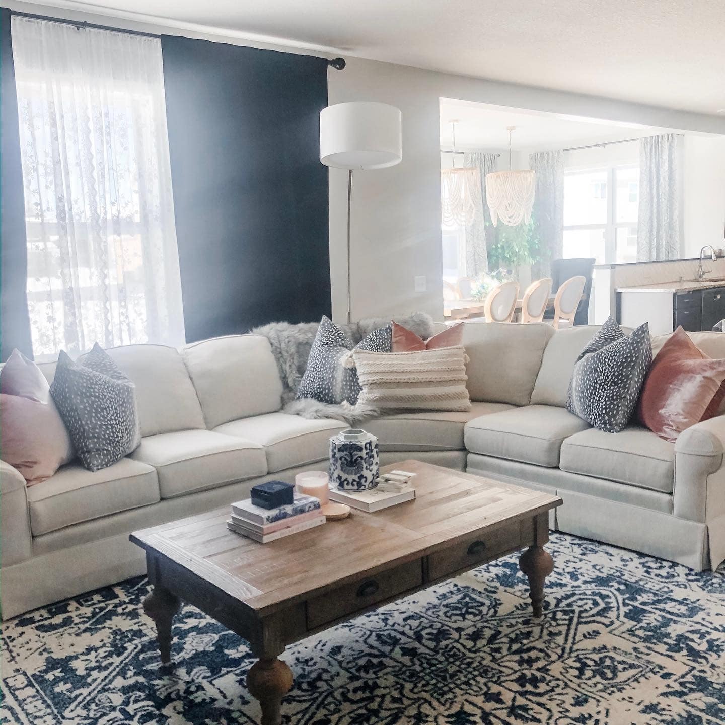 5. Classic Gray Sectional with Navy Accent Wall - navy blue and gray living room ideas