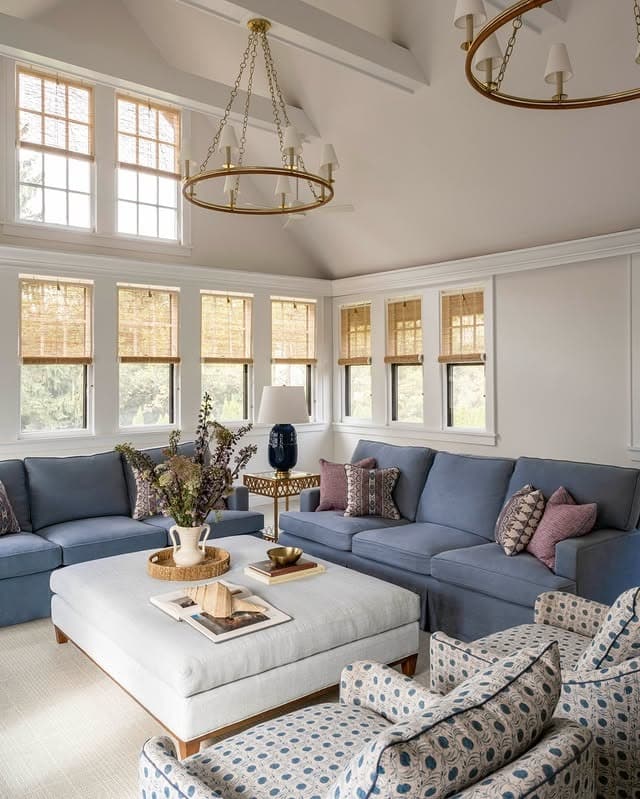 14. Refined Blue Sectionals with Warm Brass Lighting - navy blue and gray living room ideas