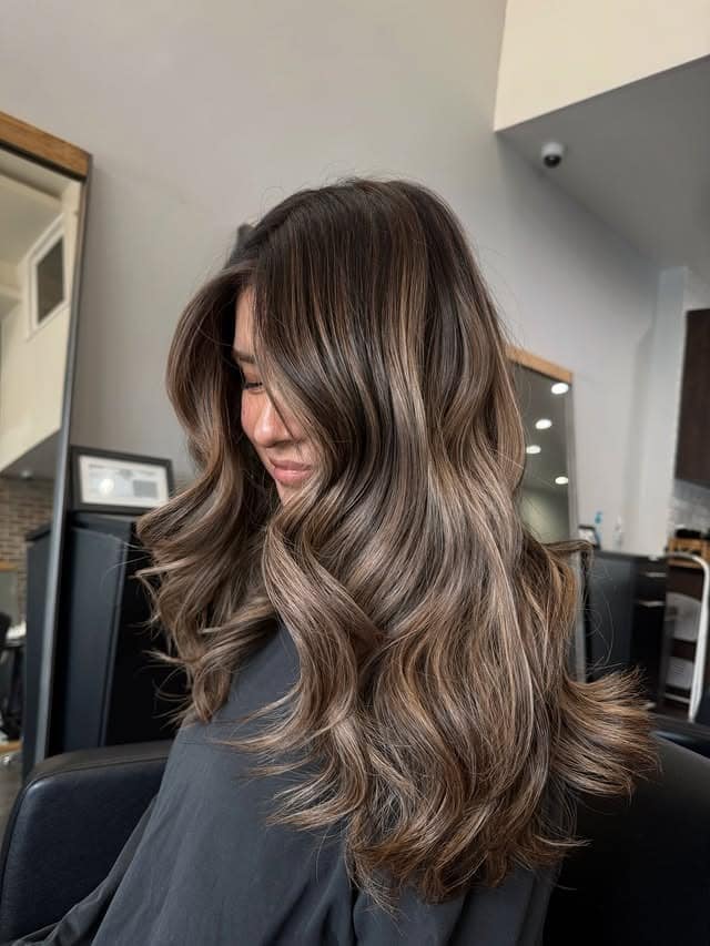 3. Voluminous Waves with Cool-Toned Brown Highlights - Medium Brown Hair with Highlights