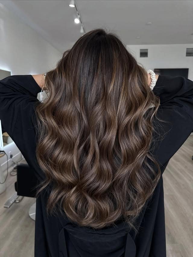 20. Glossy Wavy Finish with Soft Brown Contrast - Medium Brown Hair with Highlights