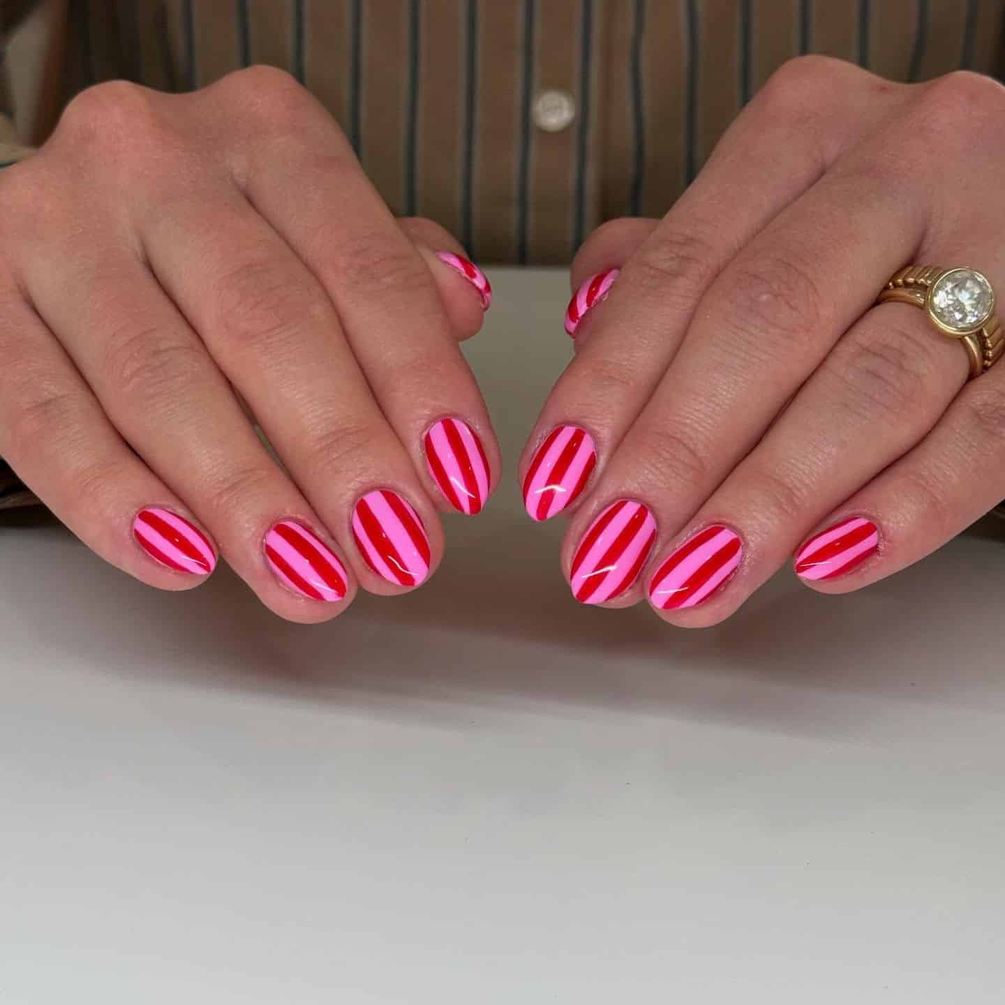5. Glossy Pink and Red Symmetrical Stripe Design - pink and red nail ideas