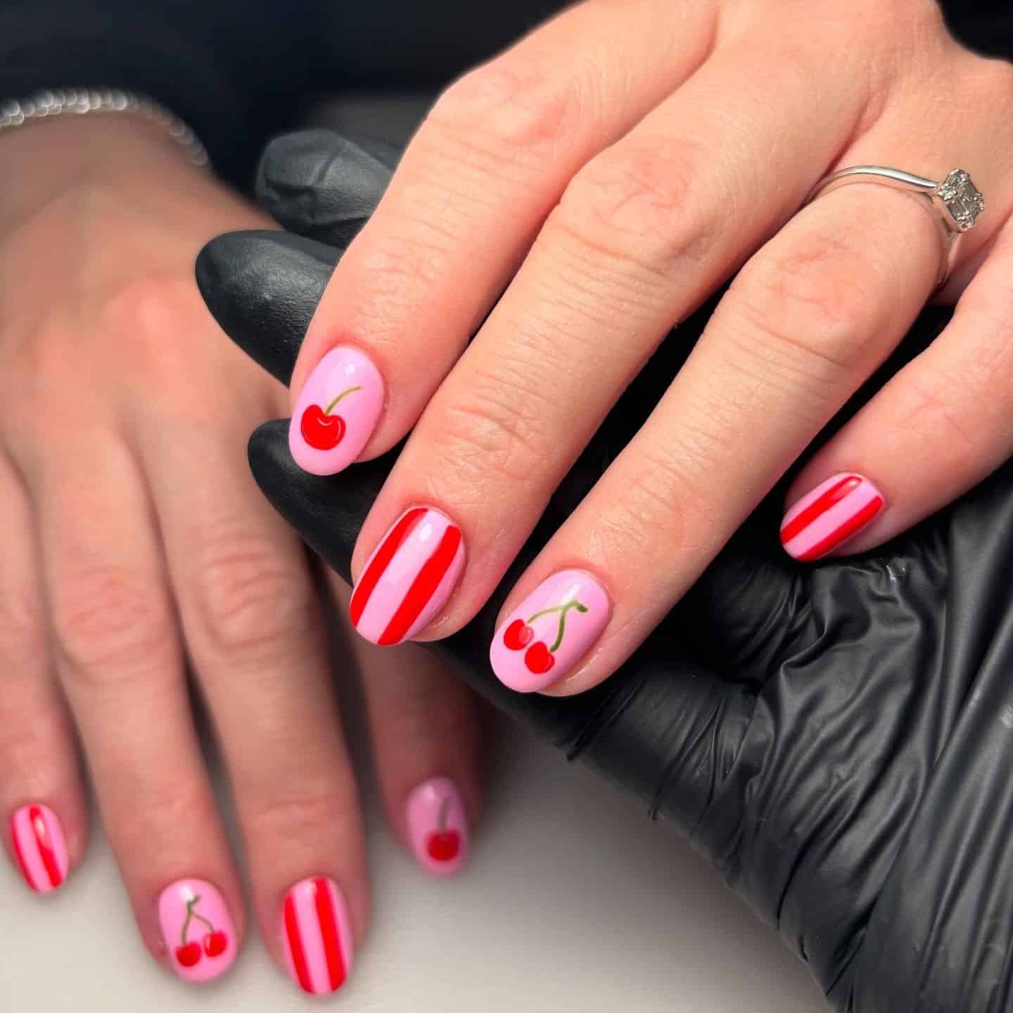 6. Pink Nails with Cherry Motifs and Red Striping - pink and red nail ideas