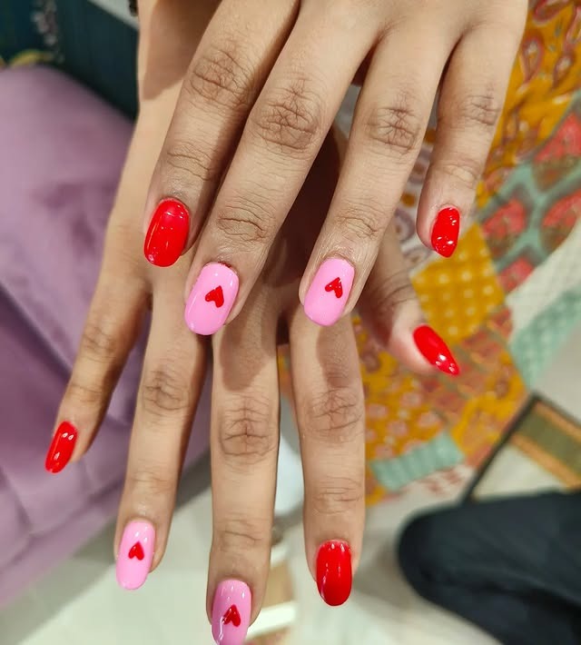 9. Pink Nails with Red Heart Accents - pink and red nail ideas
