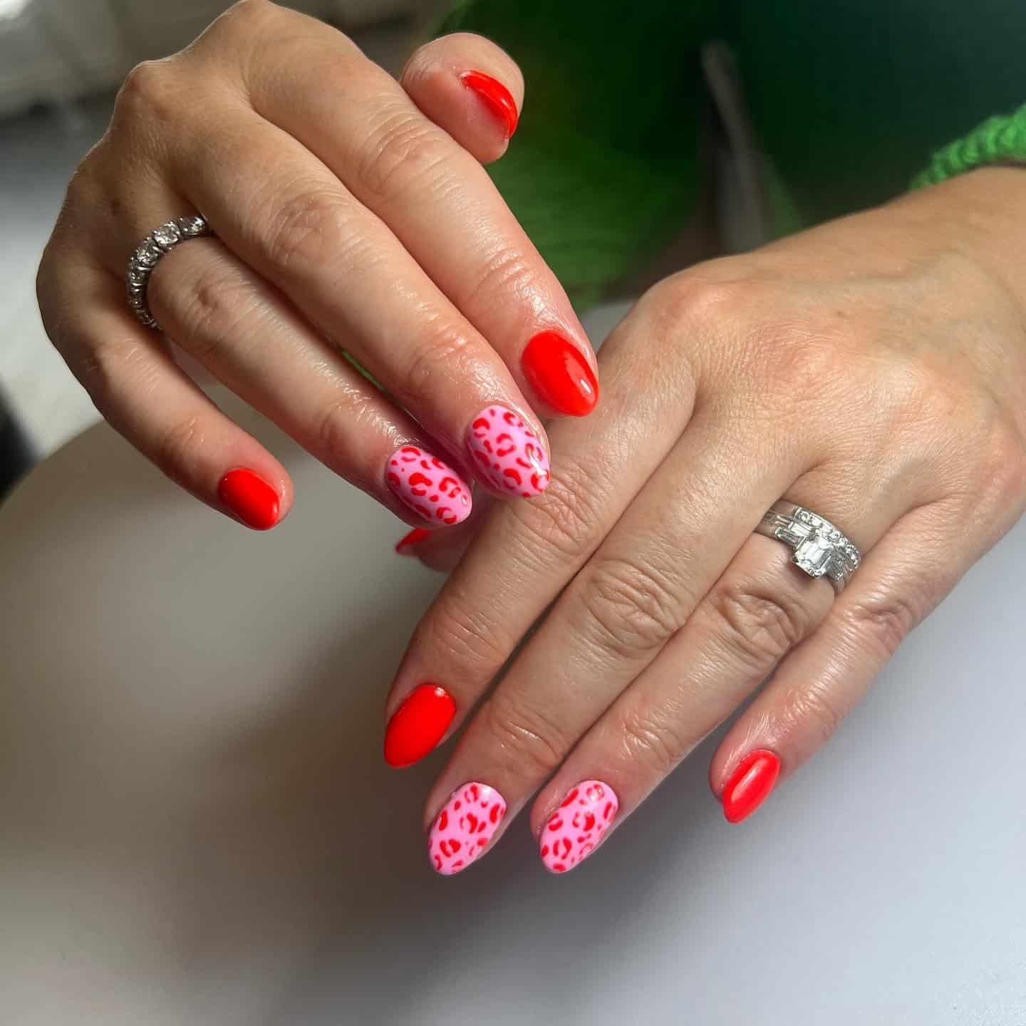 22. Red Solid Nails with Pink Leopard Accent Design - pink and red nail ideas