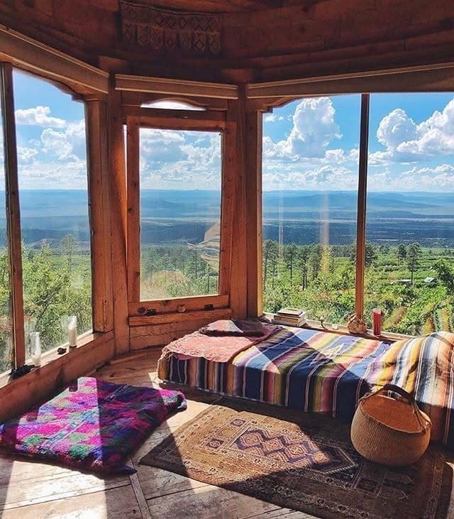 7. Scenic Cabin Bedroom with Panoramic Views and Warm Woods - nature bedroom ideas