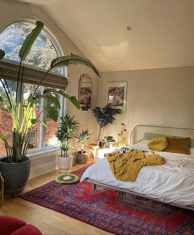 13. Sunlit Bedroom with Indoor Plants and Earthy Textiles - nature bedroom ideas