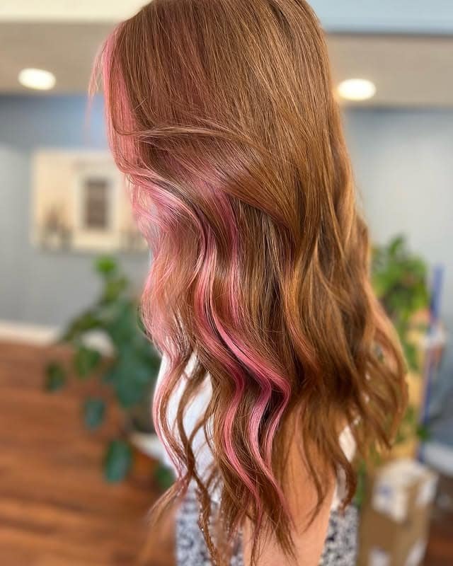 3. Subtle Pink Accents on Warm Brunette Waves - Fall Hair Colors