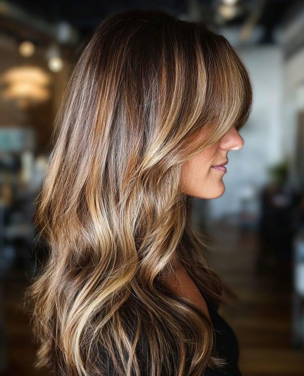 15. Warm Bronde Balayage with Soft Fringe - Fall Hair Colors