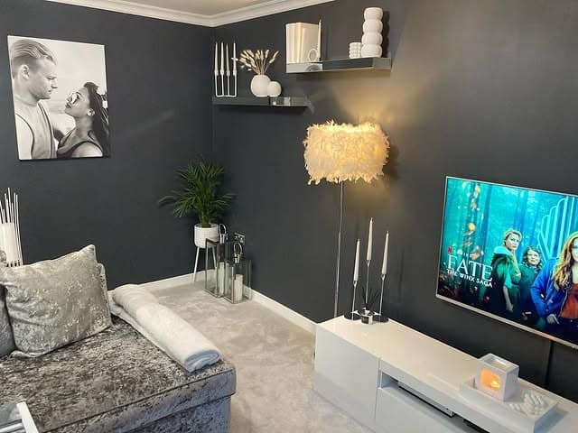 22. Modern Charcoal Living Room with Clean White Accents - dark grey living room ideas