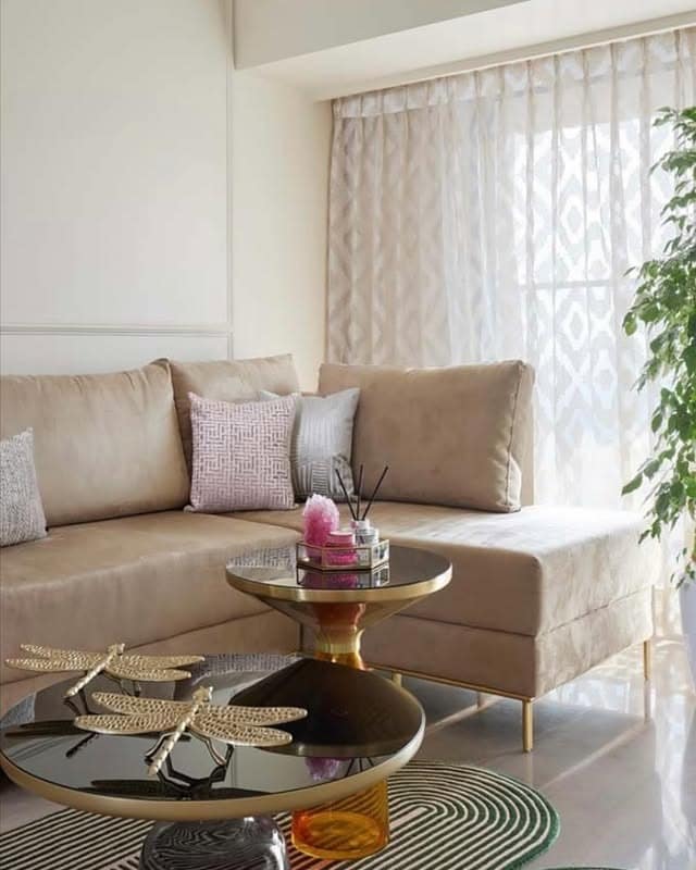 3. Contemporary Beige Seating with Brass Details - beige couch living room ideas