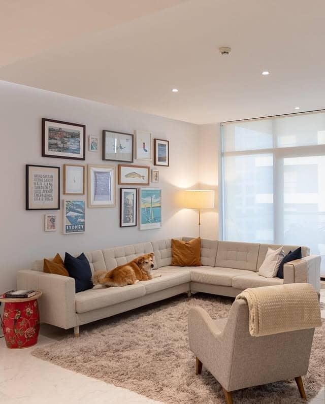 5. Gallery Wall Living Room with Beige Sectional - beige couch living room ideas