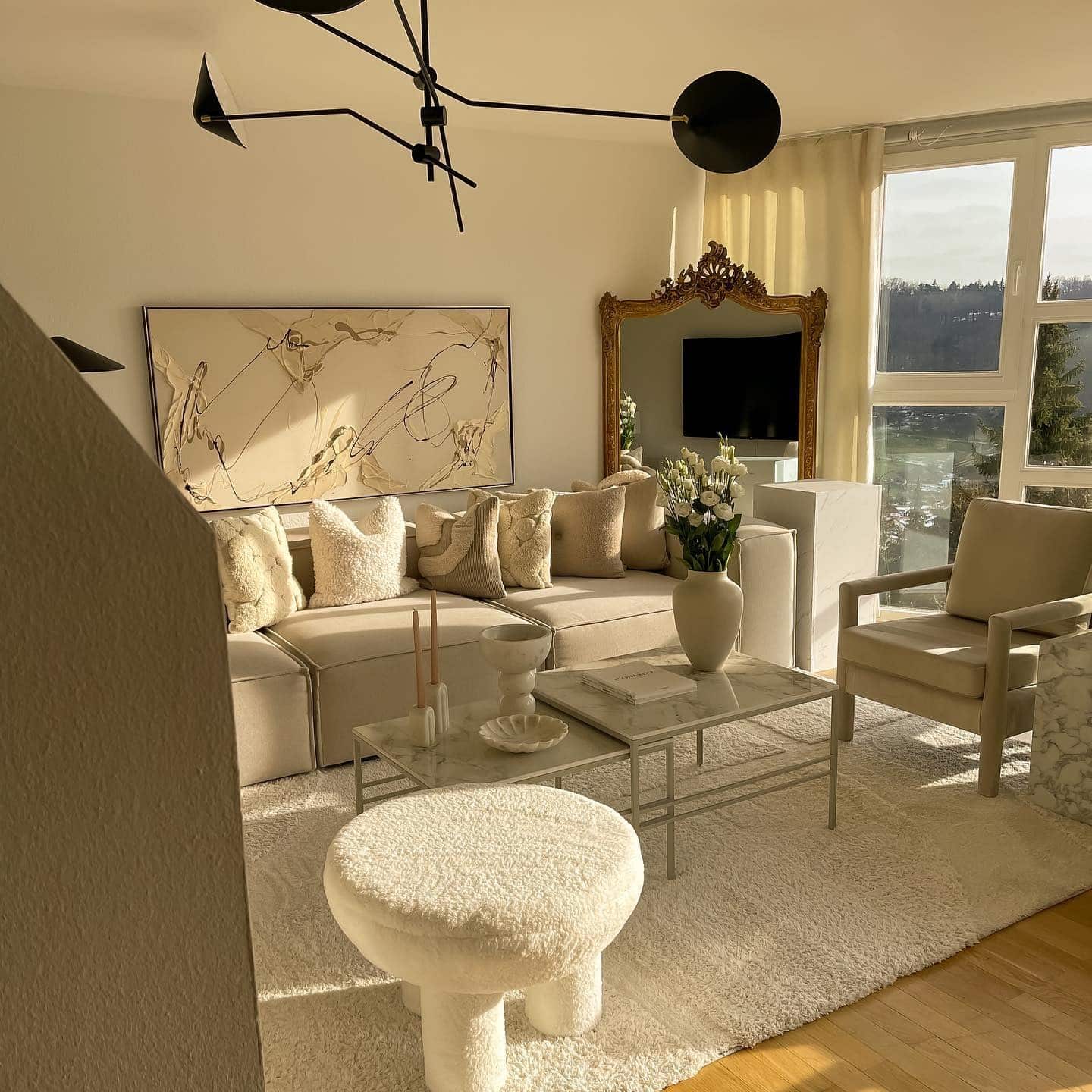 6. Elegant Beige Sofa with Sculptural Decor - beige couch living room ideas