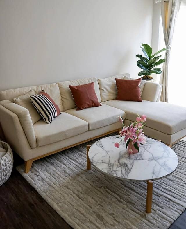 9. Casual Beige Couch with Warm Wood Accents - beige couch living room ideas