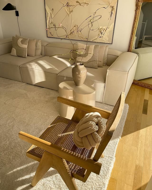 10. Refined Beige Sectional with Artful Styling - beige couch living room ideas