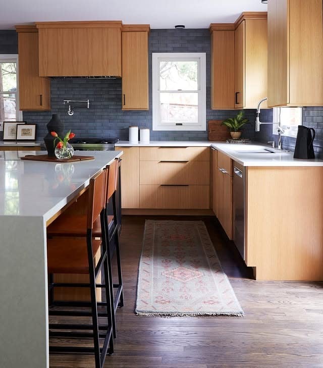 3. Warm Wood Cabinets with Matte Blue Tile Accent - blue backsplash kitchen ideas