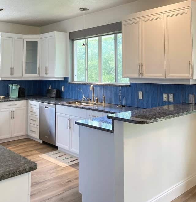 6. Airy Kitchen Design with Vertical Blue Textured Tile - blue backsplash kitchen ideas