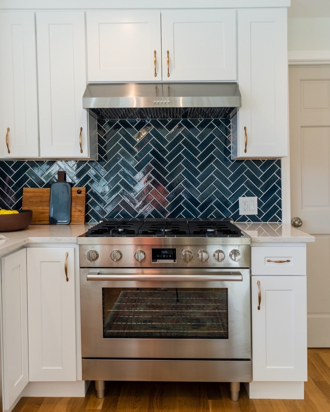 11. Classic White Kitchen with Deep Blue Herringbone Tile - blue backsplash kitchen ideas