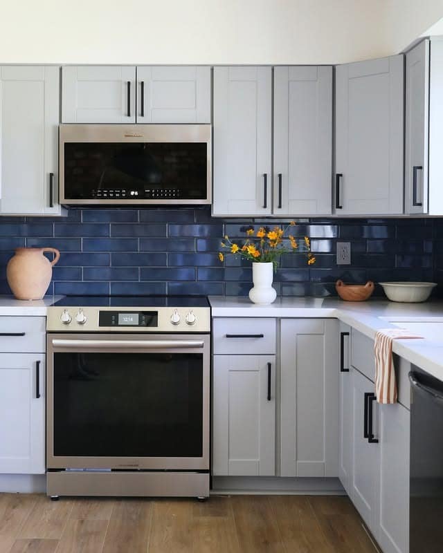16. Contemporary Gray Kitchen with Navy Subway Tile - blue backsplash kitchen ideas