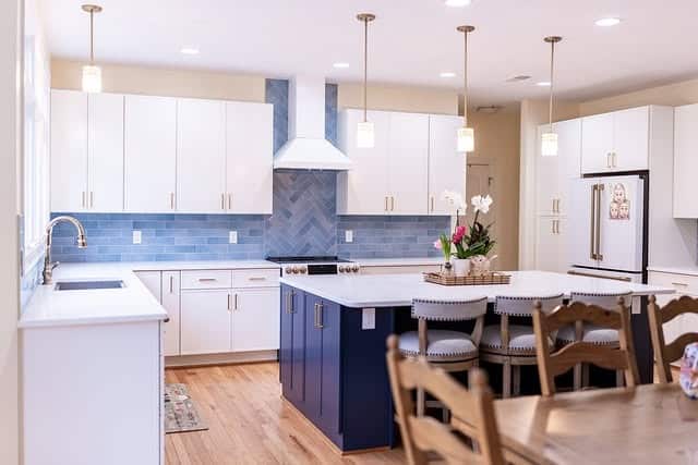 20. Open-Concept Kitchen with Blue Herringbone Accent Wall - blue backsplash kitchen ideas