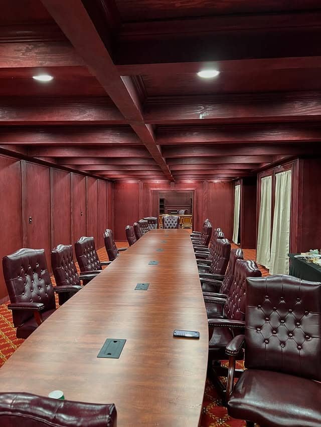 21. Boardroom-Style Office in Burgundy Wood and Espresso Leather - old money office ideas