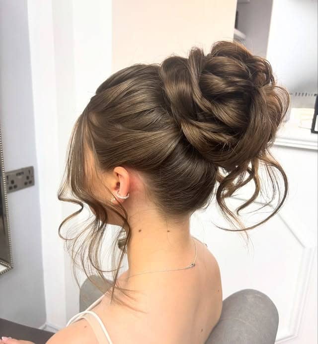 4. Elegant High Bun with Face-Framing Curls in Medium Brown - Prom Hairstyles