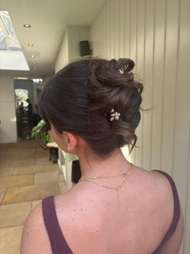 22. Textured Low Bun with Pearl Pins in Deep Espresso Brown - Prom Hairstyles
