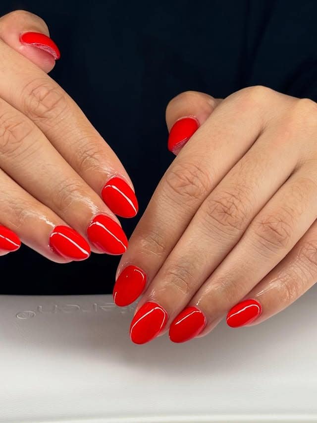 14. Bright Red Almond Studio Finish - red almond nail ideas
