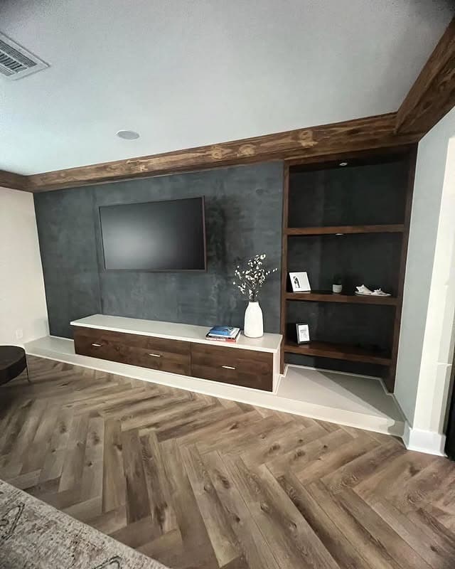 4. Charcoal Plaster Accent Wall with Built-In Media Storage - accent wall ideas for living room