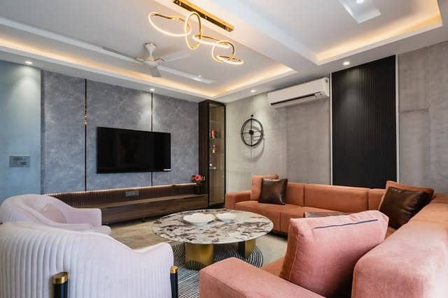 8. Modern Gray Panel Accent Wall with Sculptural Ceiling Lighting - accent wall ideas for living room